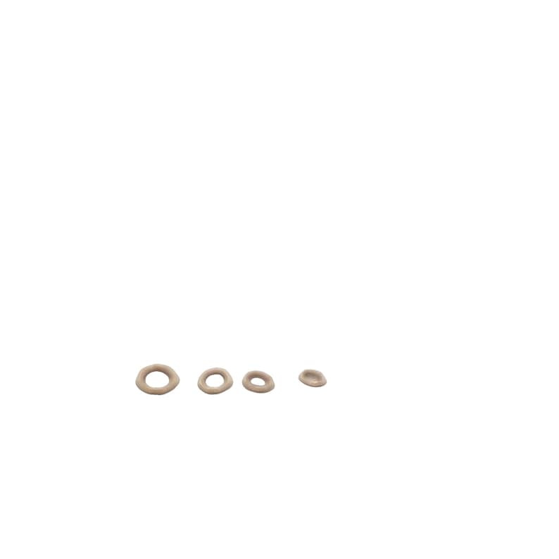 May include: Four beige-colored, ceramic rings of varying sizes. The rings are arranged in a row from largest to smallest.