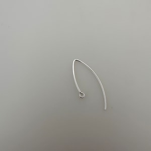 May include: Silver earring finding with a small loop at the top.