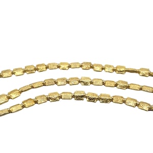 May include: Three strands of gold chain with a textured, square-shaped link design.