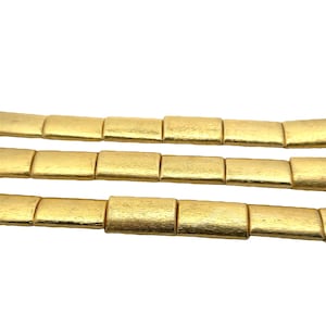 May include: A gold-toned chain necklace made of rectangular links. The chain is made of multiple strands of linked rectangles.