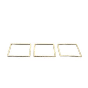 May include: Three gold square-shaped metal hoops with a hammered texture.