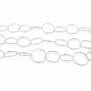 May include: A silver-toned metal chain composed of interconnected circular links. Each individual link features a textured, faceted surface that reflects light, creating a shimmering appearance across the entire length of the jewelry chain.