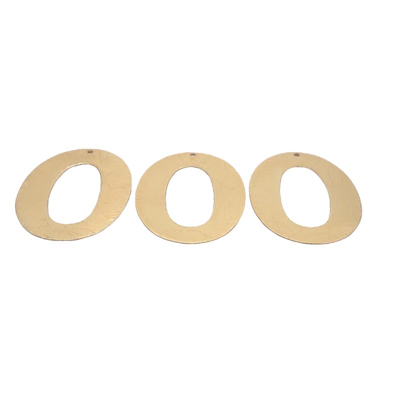 May include: Three gold-colored paper letters that spell out the word "OOO".
