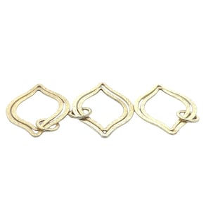 May include: Three gold-toned metal pendant charms in the shape of a teardrop with a double-loop design.