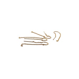 May include: Set of five gold earring chain extenders. Each extender features a delicate chain with a small loop at one end and a hook at the other.