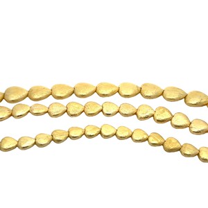 May include: A strand of gold-coloured heart-shaped beads. The beads are matte and have a slightly textured surface.