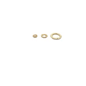 May include: Three gold jump rings with a beaded edge. The rings are different sizes.
