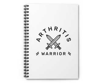 May include: White spiral notebook with a black and white graphic of two swords crossed with the text "Arthritis Warrior" in a circle around the swords.