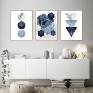 May include: Three abstract geometric prints in shades of blue and white. The prints feature a circle pattern, a geometric pattern, and a triangle pattern.