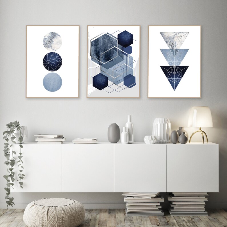 May include: Three abstract geometric prints in shades of blue and white. The prints feature a circle pattern, a geometric pattern, and a triangle pattern.