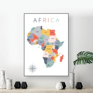 May include: A colourful map of Africa with the name "AFRICA" printed in large letters at the top. The map is divided into countries with different colours, including red, orange, yellow, green, blue, and grey. A compass is in the bottom left corner.
