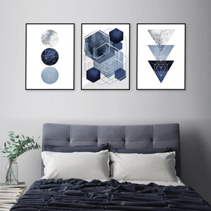 May include: Three abstract geometric prints in a blue and white color scheme. The prints feature circles, hexagons, and triangles with a textured, watercolor-like effect.