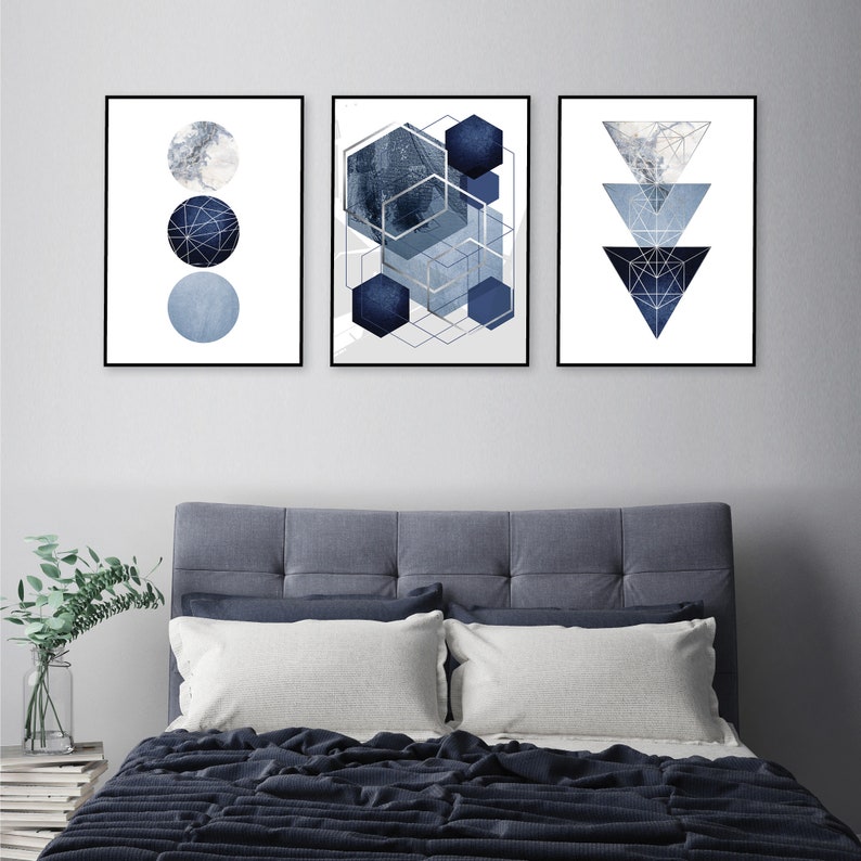 May include: Three abstract geometric prints in a blue and white color scheme. The prints feature circles, hexagons, and triangles with a textured, watercolor-like effect.