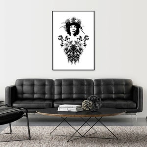 May include: Monochrome art print depicting a woman adorned with a floral crown and a decorative floral design. The artwork is framed in black and hangs above a black leather sofa. The print is a striking piece.