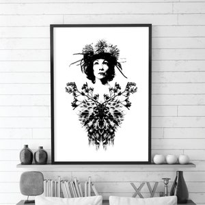 May include: Monochrome art print depicting a woman adorned with a floral crown and a detailed chest design. The artwork is framed in black and mounted on a white wall. The high-contrast image creates a bold visual statement, suitable for home decor.