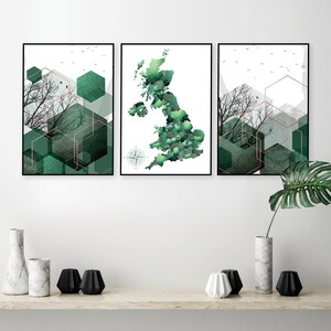 May include: Three framed prints with a geometric design featuring green and white colors. The center print shows a map of the United Kingdom with a compass in the corner. The prints are hung on a white wall.