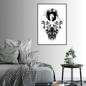 May include: Monochrome art print featuring a woman adorned with a floral headdress and a decorative chest design. The artwork is framed in black and displayed on a white wall. A stylish piece of wall decor.
