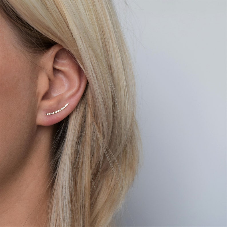 Solid gold ear climbers created in recycled 9ct gold and given a hammered finish to catch the light and add sparkle. They sit perfectly on the ear, following the natural upwards curve of the ear and are extremely comfortable. Handmade in the UK using sustainable materials and practices for an eco-friendly jewellery choice.