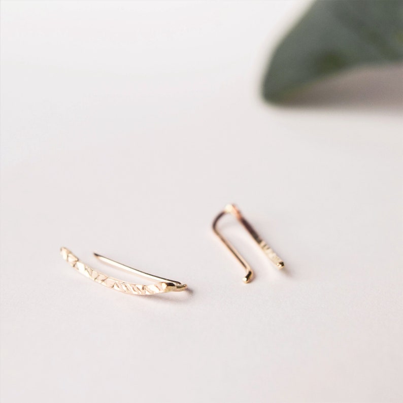 Solid gold ear climbers created in recycled 9ct gold and given a hammered finish to catch the light and add sparkle. They sit perfectly on the ear, following the natural upwards curve of the ear and are extremely comfortable. Handmade in the UK using sustainable materials and practices for an eco-friendly jewellery choice.