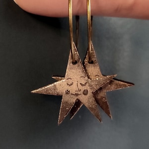 Star Earrings - Sepia & Gold. Hoop earrings in antique bronze finish with hanging stars. Laser cut wooden jewellery with decoupage