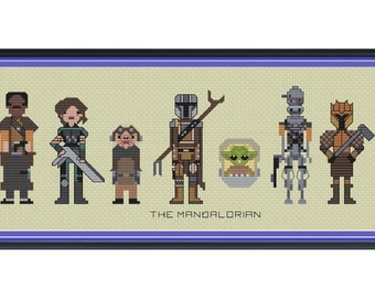 Peut inclure: Une broderie au point de croix encadrée représentant des personnages de "The Mandalorian". L'œuvre montre des personnages pixélisés du Mandalorien, Grogu et d'autres personnages. Le titre "THE MANDALORIAN" est brodé en dessous. Le cadre est noir.