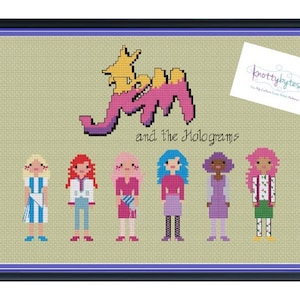 Pode incluir: Padrão de ponto cruz com a banda de desenhos animados Jem e os Hologramas. O padrão inclui o logotipo da banda e os cinco membros da banda: Jem, Kimber, Aja, Shana e Roxy. O padrão é de cor bege claro com acentos de rosa, azul e amarelo.