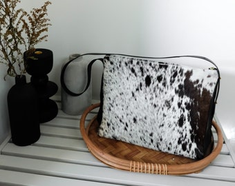 Leather cowhide tote purse for work and everyday. Lot's of pockets a zippered closure and unique hair on hide pattern.