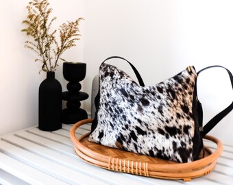 Cowhide tote leather purse with pockets, a zippered closure and black and white pattern. Salt and Pepper cowhide handbag