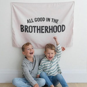 All Good In The Brotherhood Banner | Fabric Tapestry | Kids Wall Art & Bedroom/Playroom Decor | Brothers / Boyhood