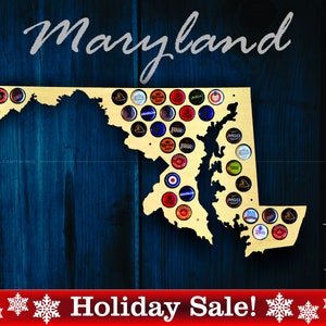 May include: A wooden cutout of the state of Maryland, filled with bottle caps, against a dark blue wood grain background. The word "Maryland" is written in cursive. The bottom of the image has the text "Holiday Sale!" and the words "Made in USA".