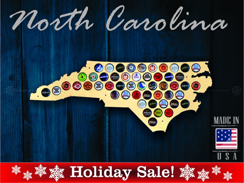 May include: A wooden cutout of the state of North Carolina, painted in a light wood color. The cutout is decorated with bottle caps, creating a mosaic pattern. The text "North Carolina" is written in a cursive font at the top of the image. The text "MADE IN USA" is written in the bottom right corner of the image. The text "Holiday Sale!" is written in red at the bottom of the image.