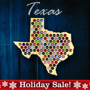 May include: A wooden cutout of the state of Texas, painted gold, with the word "Texas" above it. The cutout is decorated with bottle caps, creating a mosaic pattern. The background is a dark blue woodgrain. The text "Holiday Sale!" is at the bottom of the image, with snowflakes on either side. The text "Made in USA" is in the bottom right corner, with a small American flag.