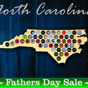 May include: A wooden cutout of the state of North Carolina, painted in a light wood color, with a design of bottle caps in the shape of the state. The background is a dark blue wood grain. The text "North Carolina" is at the top of the image, and the text "Fathers Day Sale" is at the bottom of the image. The text "Made in USA" is in the bottom right corner of the image.