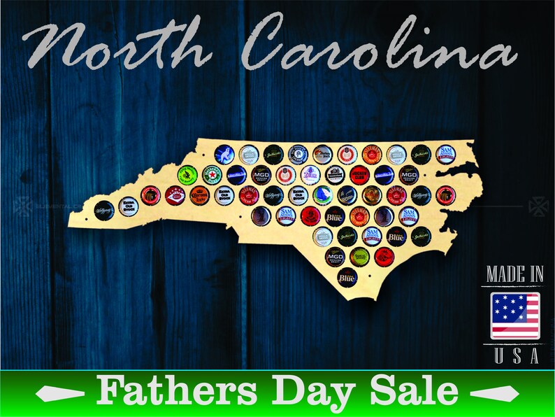 May include: A wooden cutout of the state of North Carolina, painted in a light wood color, with a design of bottle caps in the shape of the state. The background is a dark blue wood grain. The text "North Carolina" is at the top of the image, and the text "Fathers Day Sale" is at the bottom of the image. The text "Made in USA" is in the bottom right corner of the image.