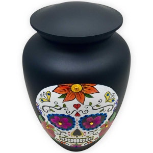 Lid view of adult-sized cremation urn featuring a white sugar skull with colorful flowers and authentic crystals on urn front.