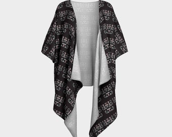 May include: Black kimono with a repeating pattern of stylized crowns. The kimono has a white lining and is open in the front.