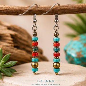May include: A pair of Heishi bead earrings, 1.5 inches long, with turquoise, red, and gold-colored beads. The earrings hang from silver-colored hooks. The text "1.5 INCH HEISHI BEAD EARRINGS" is at the bottom of the image.