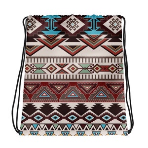 May include: A drawstring bag with a colorful geometric pattern in shades of red, brown, blue, and white. The pattern is reminiscent of Native American art.