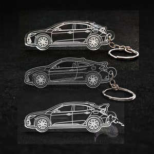 May include: Three white outline acrylic keychains of a Honda Civic hatchback. Each keychain has a silver metal ring.