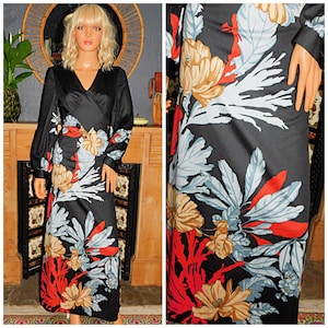 May include: A long-sleeved black dress with a floral print in shades of red, blue, white, and beige. The dress has a V-neckline and a wrap-style bodice.