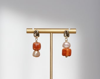 Orange painted ceramic earrings with dotted pattern, adorned with pink freshwater pearls, 14k gold plated.