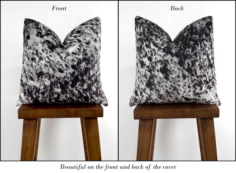 May include: Black and white cowhide patterned pillow cover. The pillow cover is shown on the front and back, with the pattern visible on both sides.