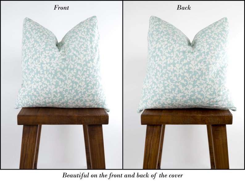 May include: A light blue pillow cover with a white floral pattern. The pillow is shown on the front and back, demonstrating the pattern is the same on both sides.