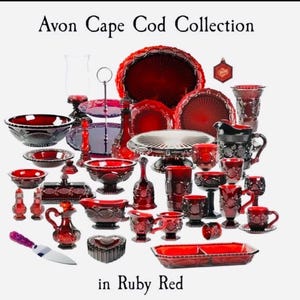 May include: A collection of ruby red glass tableware, including bowls, plates, cups, and serving dishes. The image features the text "Avon Cape Cod Collection" and "in Ruby Red". The glassware has a textured pattern and various shapes.
