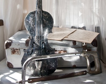 Violín: escultura metálica de tamaño natural, realista, con arco tallado con una vieja sierra de mano. Obra maestra de The Steel Style Things.