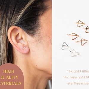 May include: Gold, rose gold, and silver triangle stud earrings. One earring is worn on an ear. The image also shows multiple pairs of earrings. Text on the image reads "HIGH QUALITY MATERIALS" and "14k gold filled, 14k rose gold filled, sterling silver."
