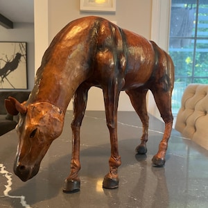 Leather wrapped grazing horse figurine