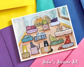 May include: A watercolour illustration of many cats resting on various patterned cushions and beds in a room with a fireplace. The cats are depicted in diverse colours and styles. The text Amber's Awesome Art is printed in white at the bottom.