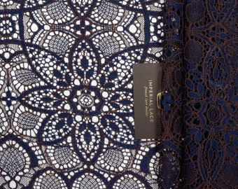 May include: Close-up of navy blue lace fabric with a brown label that reads "Imperial Lace French Lace Dealer".