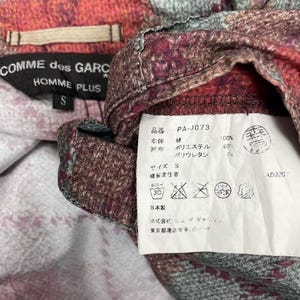 May include: A handmade wooden sign with the text "Welcome to our home" in a handwritten style. The sign is painted white with black lettering and a distressed finish, ideal for home decor.